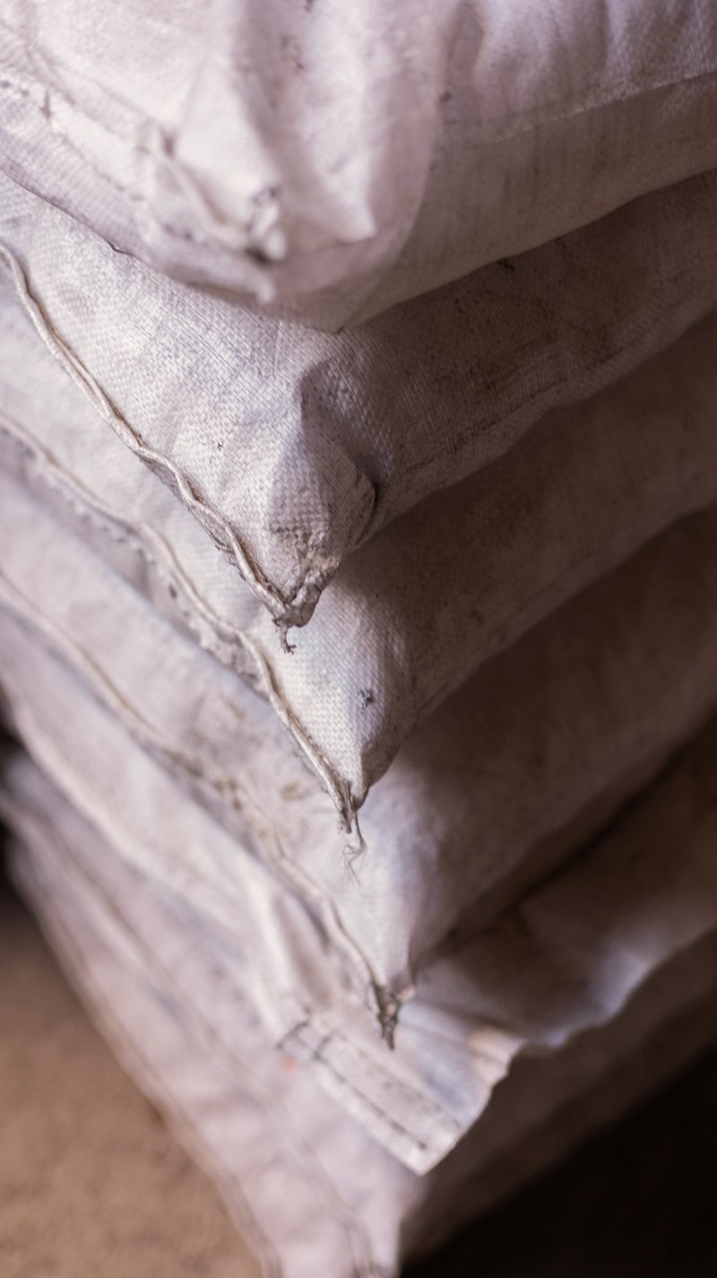 Feed sacks stacked in a storeroom