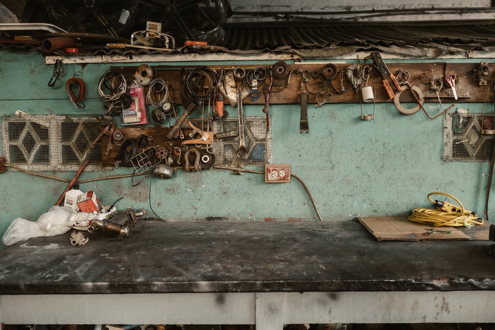 A service bench with hand tools hung on a wall rack
